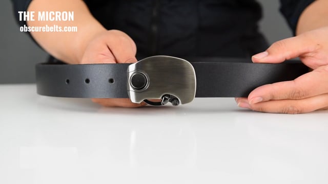 use the quick release button on the bottom of the Micron belt buckle to open it. the leather dress belt has a special sizing piece to adjust the size up to 6 inches